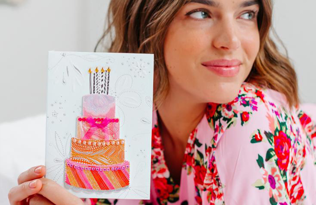Woman holding birthday cake card